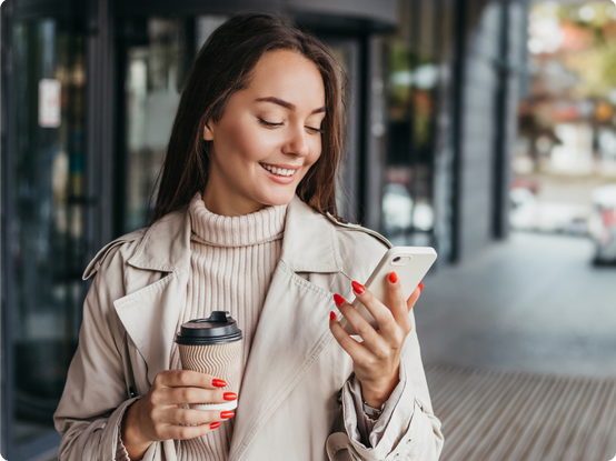 Woman smiling and looking down at her mobile phone